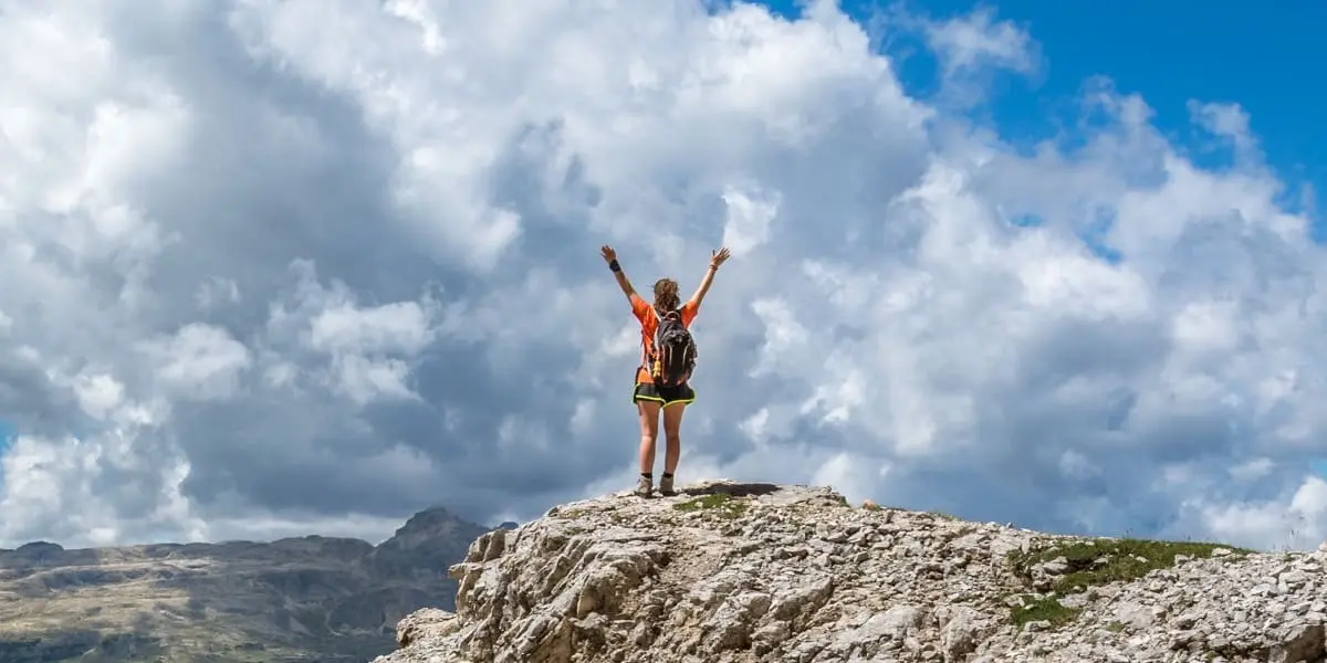 Woman hiking reaching pinnacle
