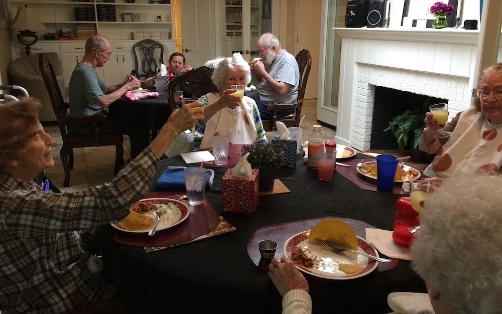 In a residential assisted living home, seniors enjoy meals together, in a dining room in a home, not a 200 person cafeteria. 