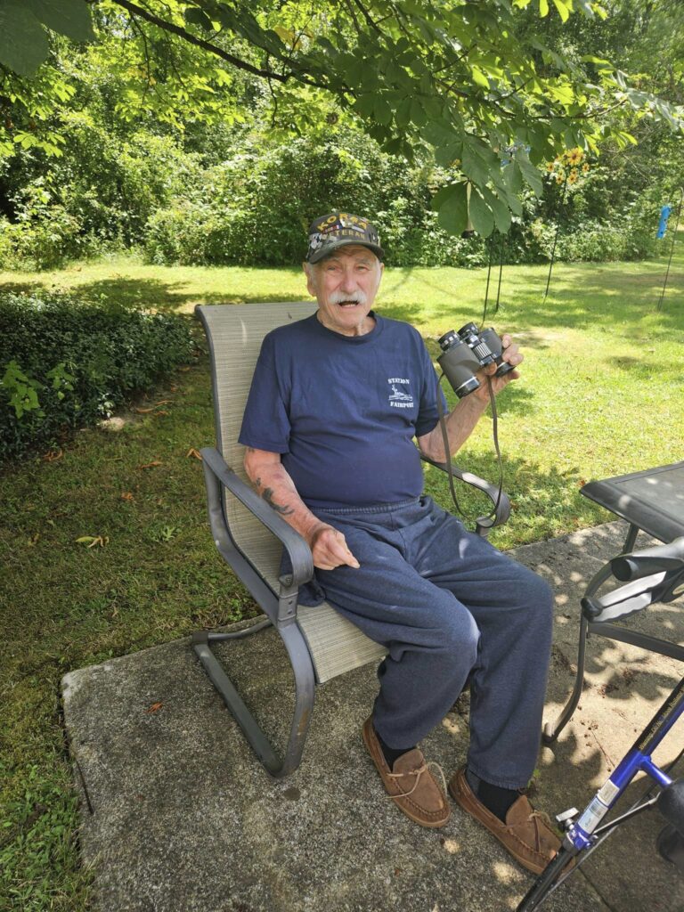 Residential assisted living resident enjoying bird watching outside of the home.