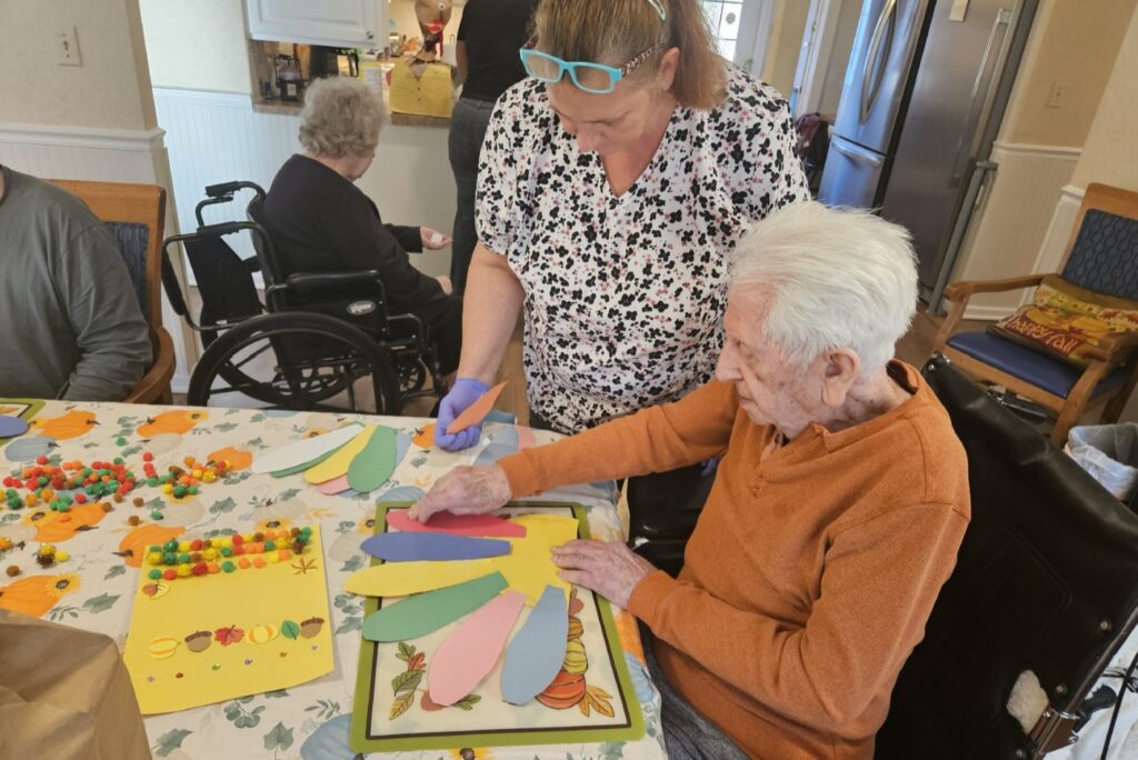 Residential assisted living resident enjoying in-home crafts and activities.