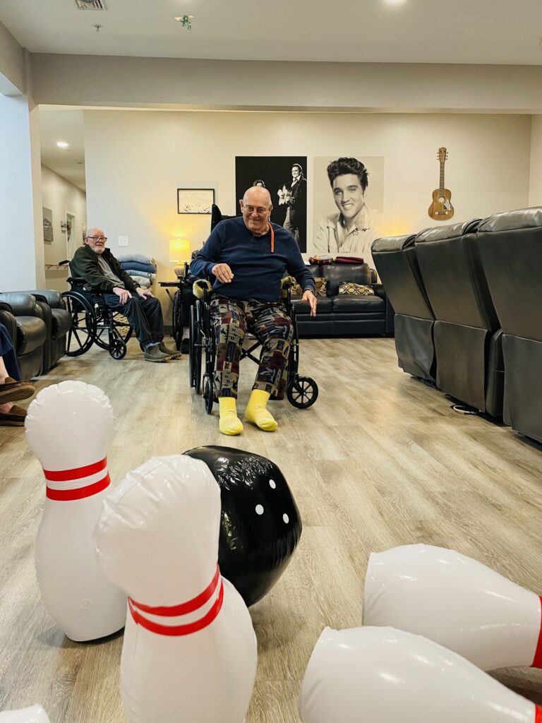 Residential assisted living community playing bowling together.